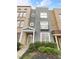 Charming townhome with a brick and stucco exterior and inviting front porch at 789 Liberty Commons Nw Dr, Atlanta, GA 30314