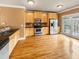 Open kitchen features stainless steel appliances, wooden cabinets, and hardwood floors at 789 Liberty Commons Nw Dr, Atlanta, GA 30314