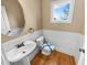Modern powder room with hardwood floors, pedestal sink, and wainscoting at 789 Liberty Commons Nw Dr, Atlanta, GA 30314