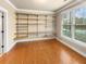 Walk-in closet with built-in shelving and hardwood floors at 789 Liberty Commons Nw Dr, Atlanta, GA 30314