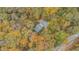 Aerial view of a house surrounded by colorful fall foliage, showcasing its secluded setting at 115 Bruce Rd, Douglasville, GA 30134