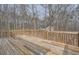 Large wooden deck overlooking a wooded backyard offers outdoor living space at 115 Bruce Rd, Douglasville, GA 30134