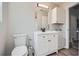 Bathroom featuring white vanity, matching linen cabinet and framed mirror, and tile floors at 115 Bruce Rd, Douglasville, GA 30134