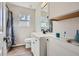 Bathroom with a white vanity, black hardware, decorative mirror, and a shower with a patterned curtain at 115 Bruce Rd, Douglasville, GA 30134