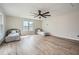 Spacious bedroom with natural light streaming through windows and French doors to a deck, plus wood-look flooring at 115 Bruce Rd, Douglasville, GA 30134