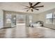 Bright bedroom featuring hardwood floors, a ceiling fan, and French doors to the outside deck at 115 Bruce Rd, Douglasville, GA 30134