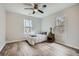 Cozy bedroom features a ceiling fan and two windows offering outdoor views at 115 Bruce Rd, Douglasville, GA 30134