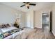 Cozy bedroom featuring light walls, fan, and wood-look flooring and a window with wooded view at 115 Bruce Rd, Douglasville, GA 30134