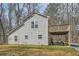 Side view of home featuring a deck, patio and gravel driveway at 115 Bruce Rd, Douglasville, GA 30134