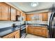 Cozy kitchen with wood cabinets, modern appliances, and a bright window view at 115 Bruce Rd, Douglasville, GA 30134