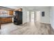 Kitchen featuring black appliances, hardwood cabinets, and an open floor plan to the rooms beyond at 115 Bruce Rd, Douglasville, GA 30134