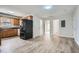 Open kitchen area with wood cabinets, stainless appliances, and an adjacent open room at 115 Bruce Rd, Douglasville, GA 30134