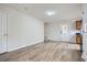 Open-concept living room features wood-look flooring, neutral walls, and ample natural light from the entry door at 115 Bruce Rd, Douglasville, GA 30134