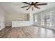 Living room with hardwood floors, neutral walls, and double doors leading to a balcony at 115 Bruce Rd, Douglasville, GA 30134