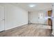 Open-concept living room features wood-look flooring, neutral walls, and ample natural light from the entry door at 115 Bruce Rd, Douglasville, GA 30134