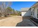 Backyard with concrete patio leading to house and side of garage at 155 Rose Creek Dr, Covington, GA 30014