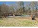 Above-ground backyard pool with wooden deck, surrounded by trees at 155 Rose Creek Dr, Covington, GA 30014