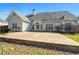 Backyard concrete patio with grass, trees, and the rear of the house at 155 Rose Creek Dr, Covington, GA 30014