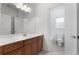 Modern bathroom with a large mirror, a white countertop, and wooden cabinets at 155 Rose Creek Dr, Covington, GA 30014