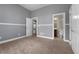 Bedroom with gray walls, carpeted floors, and a doorway to the bathroom at 155 Rose Creek Dr, Covington, GA 30014