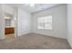 Bright bedroom features neutral carpet, a double closet, and a window for natural light at 155 Rose Creek Dr, Covington, GA 30014