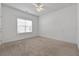 Bedroom with carpeted floors, a ceiling fan, and a window for natural light at 155 Rose Creek Dr, Covington, GA 30014