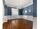 Elegant dining room features rich hardwood floors, wainscoting, and stylish chandelier at 155 Rose Creek Dr, Covington, GA 30014