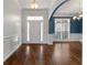 Inviting foyer showcasing hardwood floors, wainscoting, and an open view to the dining area at 155 Rose Creek Dr, Covington, GA 30014