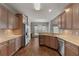 Modern kitchen with stone counters, wood cabinets and stainless appliances flows to breakfast nook at 155 Rose Creek Dr, Covington, GA 30014