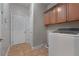 Laundry room with tile floors, utility sink, overhead cabinets, and a white washer at 155 Rose Creek Dr, Covington, GA 30014