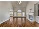 Bright living room features vaulted ceiling, large windows, fireplace and beautiful hardwood floors at 155 Rose Creek Dr, Covington, GA 30014