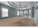 Large main bedroom with tray ceiling, neutral carpet and many light-filled windows at 155 Rose Creek Dr, Covington, GA 30014