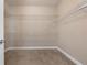 Walk-in closet with installed shelving and carpeted floor at 155 Rose Creek Dr, Covington, GA 30014