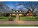 Charming single-story brick home with manicured lawn and a welcoming front porch at dusk at 545 Highway 155 N, Mcdonough, GA 30253