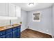 Bright laundry room with wooden counters and white cabinets at 545 Highway 155 N, Mcdonough, GA 30253