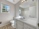 Well-lit bathroom with a white vanity, large mirror, and a shower-tub combination for relaxation at 63 Avery Way, Dallas, GA 30157