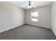 Cozy bedroom with neutral carpet, ceiling fan, and a window providing natural light at 63 Avery Way, Dallas, GA 30157