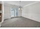 Formal dining room featuring a decorative light fixture and French doors at 63 Avery Way, Dallas, GA 30157