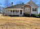 Charming home featuring a welcoming front porch and a mix of stone and siding accents at 63 Avery Way, Dallas, GA 30157