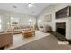 Bright living room with a vaulted ceiling, a stone fireplace, and large windows at 63 Avery Way, Dallas, GA 30157