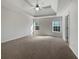 Bright main bedroom with tray ceiling, plush carpet, and natural light from large windows at 63 Avery Way, Dallas, GA 30157