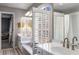 Bright bathroom with double vanity, white shutters, and plenty of natural light at 9465 Mistwater Close, Roswell, GA 30076