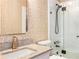 Stylish bathroom featuring gold-patterned wallpaper, granite countertop, and glass-enclosed shower at 9465 Mistwater Close, Roswell, GA 30076