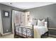 Comfortable bedroom featuring a black metal bed frame and neutral decor at 9465 Mistwater Close, Roswell, GA 30076