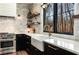 Well-lit kitchen with stainless steel appliances, white countertops, and farmhouse sink at 9465 Mistwater Close, Roswell, GA 30076