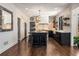 Open concept kitchen with island, brick backsplash, and hardwood floors at 9465 Mistwater Close, Roswell, GA 30076