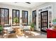 Bright sun room with black trim windows, and light colored flooring at 9465 Mistwater Close, Roswell, GA 30076