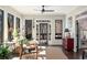 Bright sun room with hardwood floors, a ceiling fan, and a view of the surrounding landscape at 9465 Mistwater Close, Roswell, GA 30076