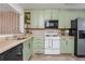 Well-lit kitchen featuring modern cabinetry, appliances, and tile backsplash at 1323 Weatherstone Ne Way, Atlanta, GA 30324