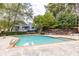 A refreshing swimming pool with a concrete deck and a view of the surrounding trees and building at 1323 Weatherstone Ne Way, Atlanta, GA 30324